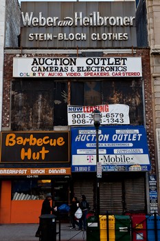 Old and new shop signs remain prominent on Broad Street in Newark, NJ.